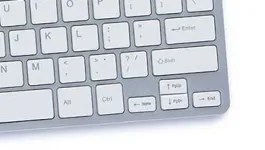silver keyboard with white buttons on white background