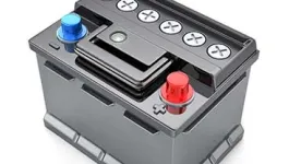 Close-up of a dark gray car battery with a red positive terminal and a blue negative terminal.