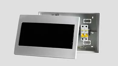 A silver electrical panel with its cover, which has a black window, removed to show two circuit breakers inside.